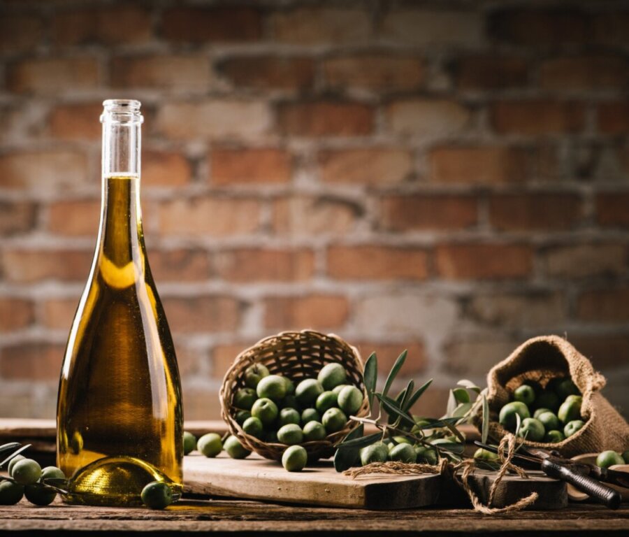 olive-oil-with-fresh-olives-rustic-wood-close-up (1)